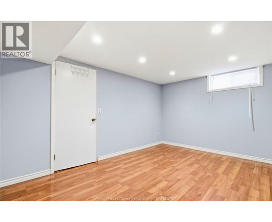 A room with a white door and a window with blinds.
