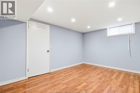 A room with a white door and a window with blinds.