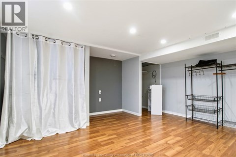 A room with wooden floors and a white ceiling.