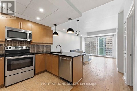 A kitchen with a stove top oven, microwave, and dishwasher.