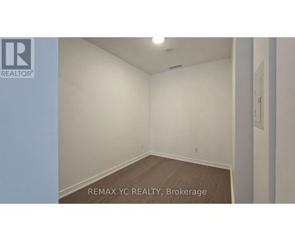 A room with a white wall and a wooden floor.