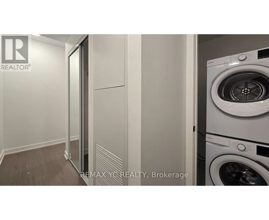 A white washing machine in a laundry room.