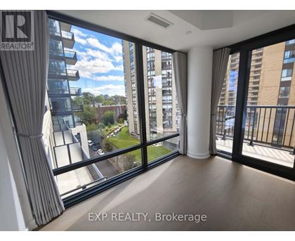 A room with large windows overlooking a cityscape.