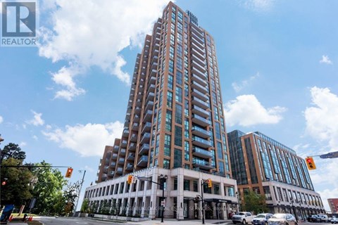 A tall building with many windows is in the center of the image.