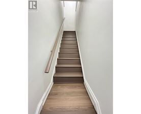 A staircase with wooden steps and a handrail.