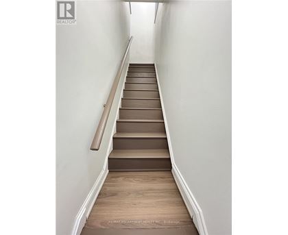 A staircase with wooden steps and a handrail.