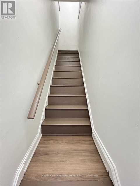 A staircase with wooden steps and a handrail.