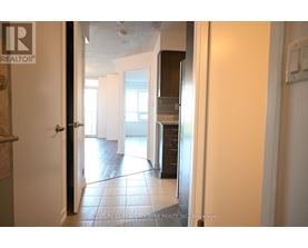 A hallway with a black door and a white door.