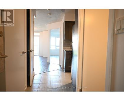 A hallway with a black door and a white door.