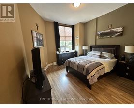 A bedroom with a large bed and a flat screen TV.