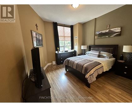 A bedroom with a large bed and a flat screen TV.
