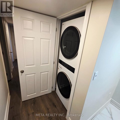 A white door with a washing machine behind it.