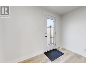 A white door with a black handle and a window on the right side.
