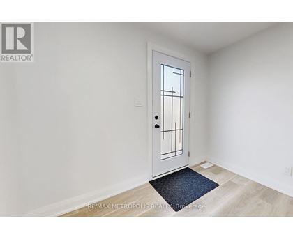 A white door with a black handle and a window on the right side.