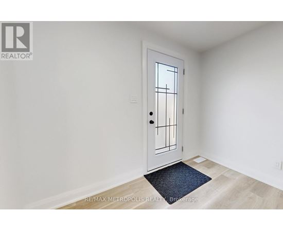 A white door with a black handle and a window on the right side.