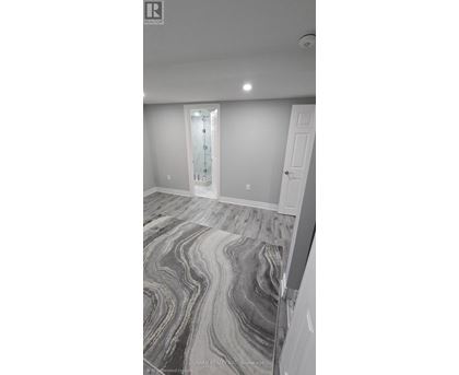 A room with a marble floor and a white door.