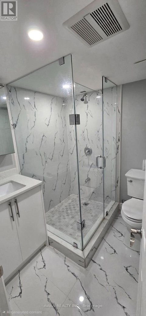 A bathroom with a marble floor and a walk-in shower.