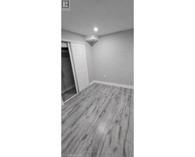 A room with a wooden floor and a white door.