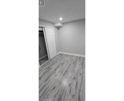 A room with a wooden floor and a white door.