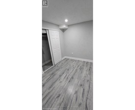 A room with a wooden floor and a white door.