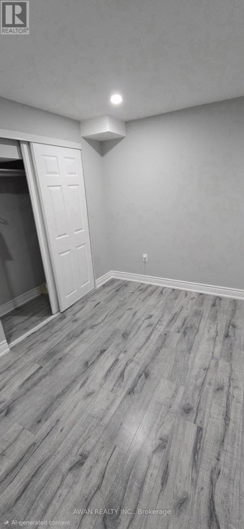 A room with a wooden floor and a white door.