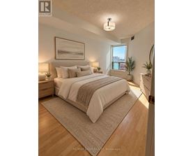 A bedroom with a large bed and a painting on the wall.