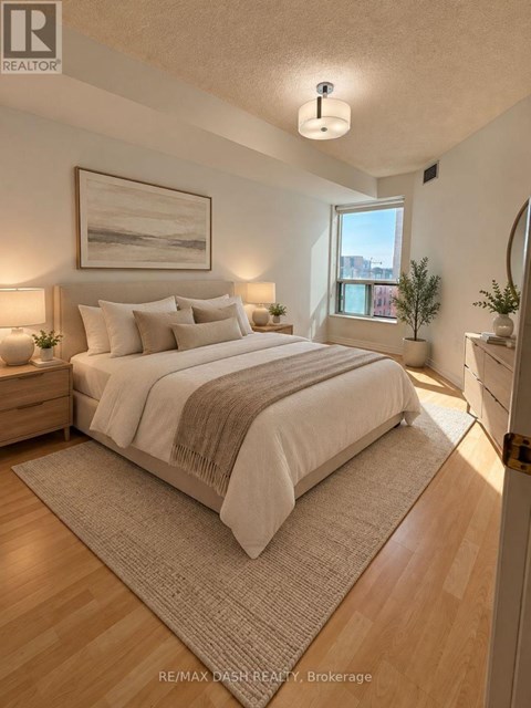A bedroom with a large bed and a painting on the wall.