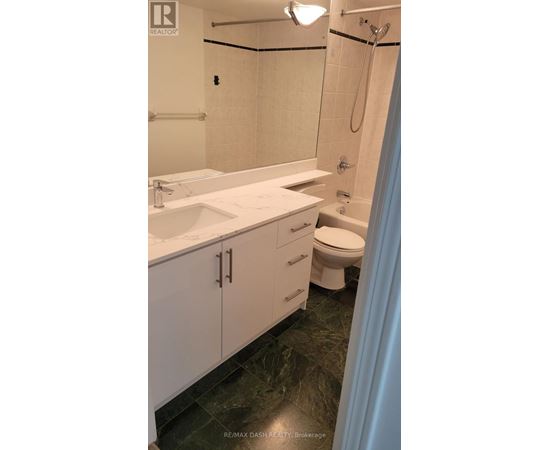 A bathroom with a sink, toilet, and shower.