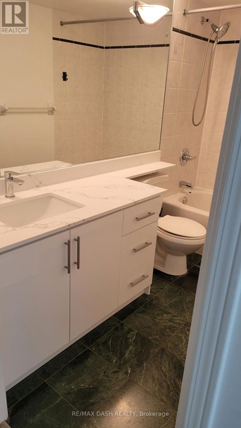 A bathroom with a sink, toilet, and shower.