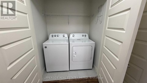 A small laundry room with two washing machines.