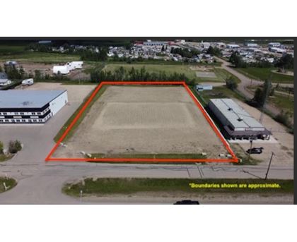 An aerial view of a field with a red boundary line.