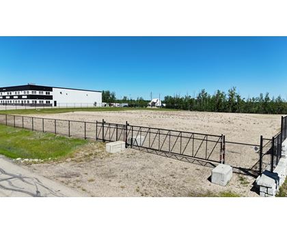 A white building with a black fence in front of it.