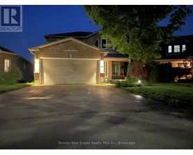 A house with a lit up driveway at night.
