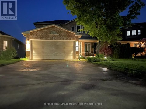 A house with a lit up driveway at night.