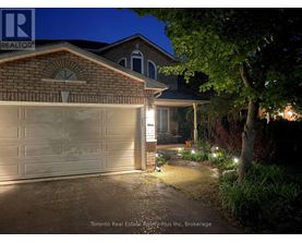 A house with a lit up garage door at night.