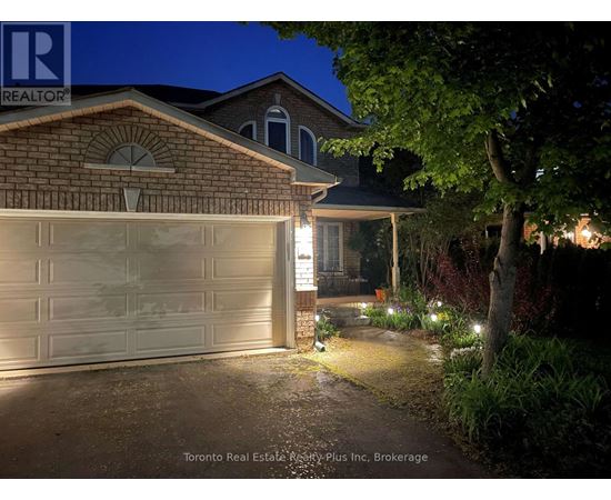 A house with a lit up garage door at night.