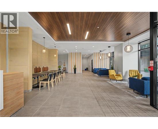 A modern office space with a long table and chairs.