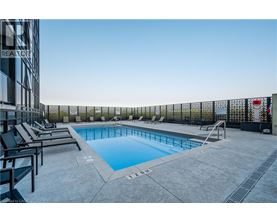 A pool surrounded by a black fence with the number 12 on it.