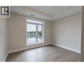 A room with a large window overlooking a body of water.