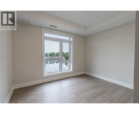 A room with a large window overlooking a body of water.