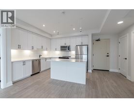 A modern kitchen with white cabinets and a central island.