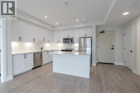 A modern kitchen with white cabinets and a central island.