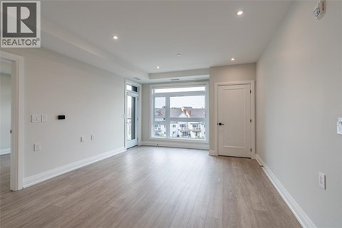 A spacious room with a sliding glass door leading to a balcony.