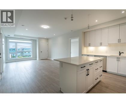 A spacious kitchen with white cabinets and a large island.