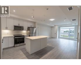 A spacious kitchen with white cabinets and a large island.