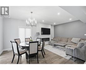 A modern dining room with a glass table and chairs.