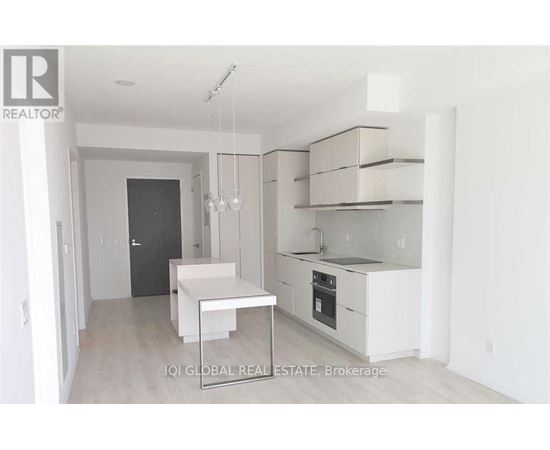 A white kitchen with a table and chairs.