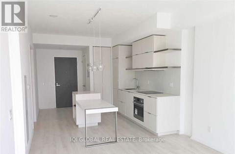 A white kitchen with a table and chairs.