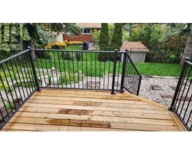 A wooden deck with a metal railing.