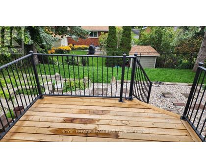 A wooden deck with a metal railing.